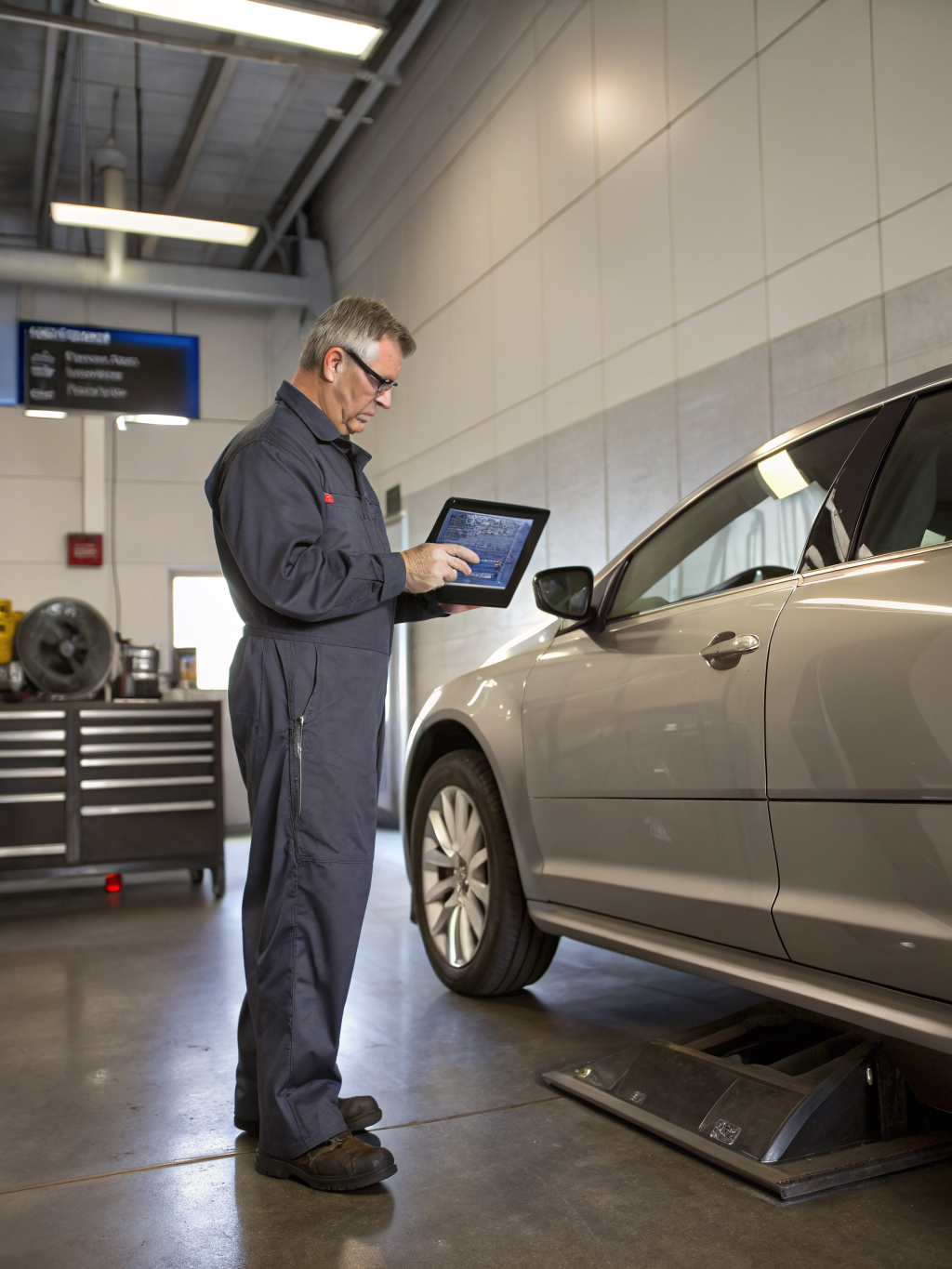 Technician preparing for vehicle work at Birmingham Auto Centre Ltd